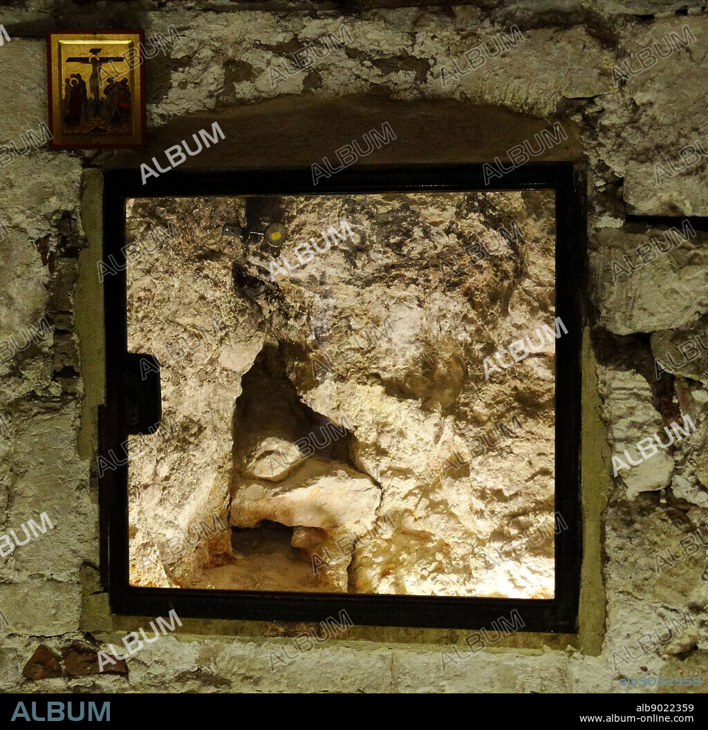 Hill of Calvary (Golgotha,) Crack in the Rock of Golgotha through a viewing window; Chapel of Adam in the Church of the holy Sepulchre. The Church of the Holy Sepulchre in Jerusalem is identified as the place both of the crucifixion and the tomb of Jesus of Nazareth. Originally built by the mother of Emperor Constantine in 330 A.D. The original Byzantine church was destroyed by the Persians in AD 614.
