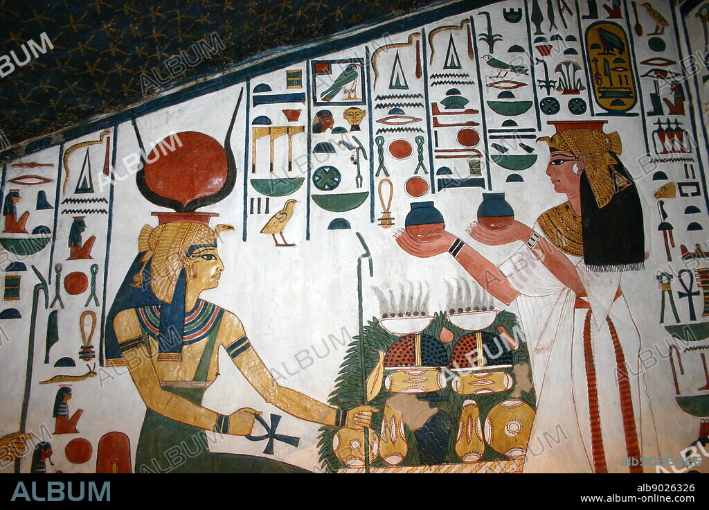 Wall Painting depicting, the Goddess Isis with Nefertari, Great Wife of Pharaoh Ramesses II, Inside the tomb (QV66) of Nefertari, in Egypt's Valley of the Queens. It was discovered by Ernesto Schiaparelli in 1904. It is called the Sistine Chapel of Ancient Egypt. In the Valley of the Queens, Nefertari's tomb once held the mummified body and representative symbolisms of her, like what most Egyptian tombs consisted of. Now, everything had been looted except for two thirds of the 5,200 square feet of wall paintings. ca. 1255 BC.