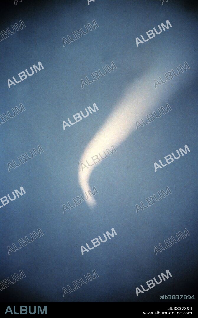 Funnel cloud, a tornado that isn't on the ground. Near El Reno, Oklahoma July 1973. A funnel cloud is a funnel-shaped cloud of condensed water droplets, associated with a rotating column of wind and extending from the base of a cloud (usually a cumulonimbus or towering cumulus cloud) but not reaching the ground or a water surface. A funnel cloud is usually visible as a cone-shaped or needle like protuberance from the main cloud base. Funnel clouds form most frequently in association with supercell thunderstorms. If a funnel cloud touches the ground it becomes a tornado. Most tornadoes begin as funnel clouds, but many funnel clouds do not make ground contact and so do not become tornadoes.