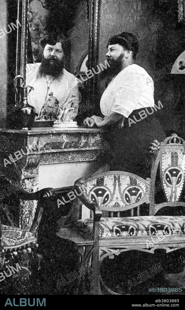 ClÃ©mentine Clatteaux Delait (March 5, 1865 - Apri 5, 1939) was a French bearded lady. Her facial hair began growing while she was a teenager. In 1885, she married a local baker, changed her name to Delait and opened a cafÃ© and bakery in the village of Taon-les-Vosges. Until that point Clementine had shaved off her beard every day, but while working at the cafÃ© she made a bet with a customer to let it grow. The bet attracted many more customers to the Delaits' cafÃ© and they changed the name to Le CafÃ© de La Femme Ã  Barbe (The cafe of the Bearded Woman). Her fame spread and she received invitations from as far away as America, but Clementine was a devoted wife who refused them all to remain with her husband who was in ill-health. Unlike many other bearded women of the time, Clementine did not succumb to pressure to join a circus, but she did sell photographs of herself. When her husband died in 1928, Clementine finally accepted invitations to visit the famous Paris funfair, La Foire du Trone and travelled abroad to London and Ireland. No photographer credited, 1910s.