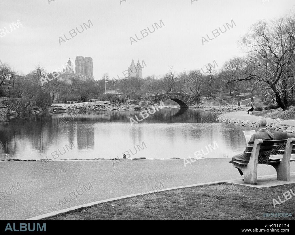 Man reading Newspaper, Gapstow Bridge and Pond, Central Park, New York City, New York, USA, Angelo Rizzuto, Anthony Angel Collection, April 1956.