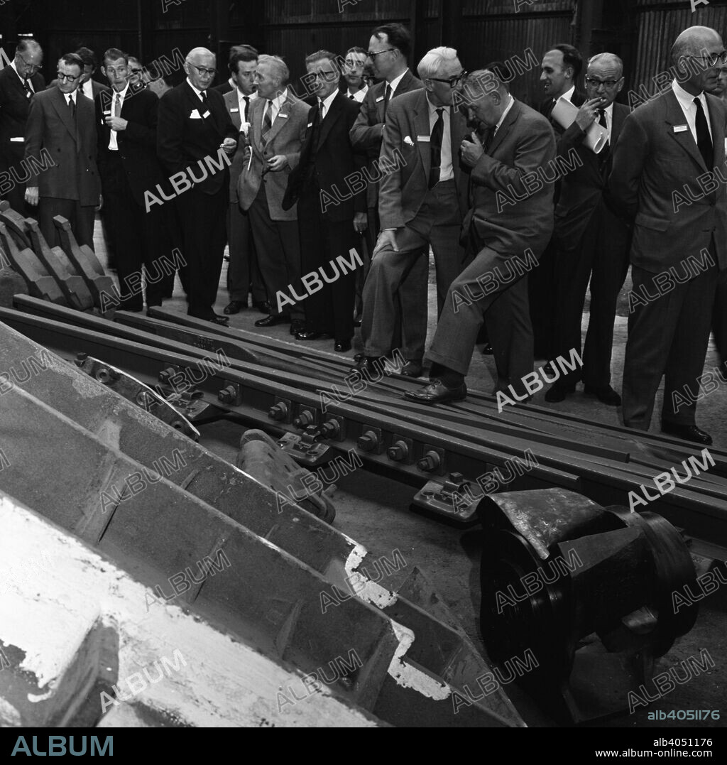 Visitors inspect a tram junction, which has been made at the Edgar Allen steel foundry, Meadowhall, Sheffield, 21 June 1962. It was said at the time that there were only two places in the world where hardened manganese steel tram junctions could be made and they were both located in the same road in Sheffield. Renowned throughout the world for the quality of its steel, Sheffield exported steel globally during the 60s.