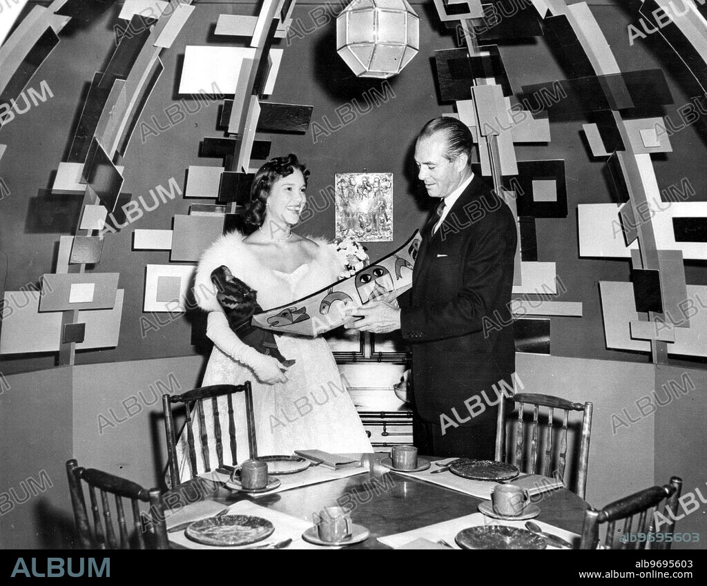 Miss America of 1959, Mary Ann Mobley admires examples of native Alaskan folk art with designer William Pahlmann at the Home Furnishings Show. 13 September 1958.