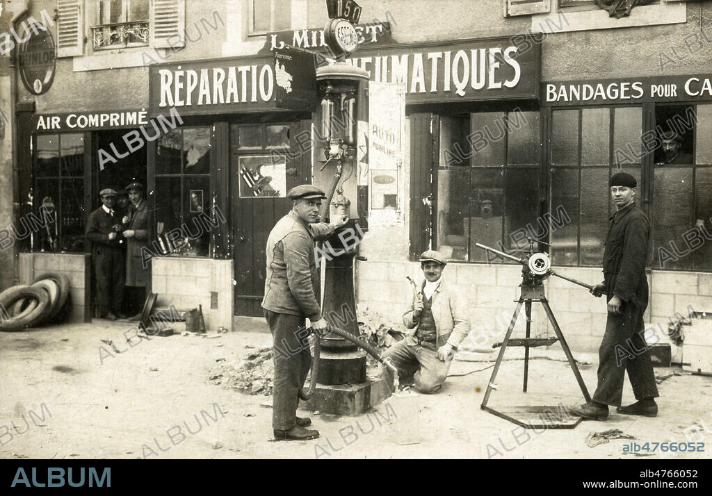 Pompistes devant une station essence. Photographie anonyme pour une carte postale vers 1920. Credit : Collection IM/KHARBINE-TAPABOR.