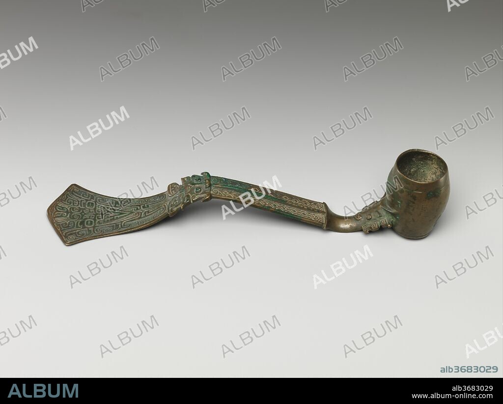 Ritual ladle (Shao). Culture: China. Dimensions: H. 1 3/4 in. (4.4 cm); Diam. 1 1/16 in. (2.7 cm); L. 8 in. (20.3 cm); Wt. 1 lb. (0.5 kg). Date: late 11th century B.C..
This elaborate set of wine vessels provides an idea of the splendor of Shang and early Zhou ritual ceremonies. The set is said to have come from a tomb uncovered in 1901; shortly thereafter, it entered the collection of Duan Fang, a senior Manchu official and one of the preeminent antiquarians of the late Qing period. 
The pieces vary in style and execution. Although eleven of the vessels are inscribed, only one grouping shares identical inscriptions: the two wine containers, or you (nos. 2, 3) and the tall wine container, or zun (no. 4). A second grouping has largely comparable inscriptions: the spouted water vessel, or he (no. 5) and one cup, or zhi (no. 11).
A partial reconstruction of the set's arrangement in the tomb may be established from corrosion outlines on the three principal vessels--the two wine containers, or you, and the central tall wine container, or zun--that were etched onto the surface of the altar table. The diagram shows a hypothetical arrangement of the remaining vessels around the major pieces. Even if this is accepted as the original grouping, the disparate inscriptions and vessel styles remain unexplained. Created around the time of the Zhou conquest of the Shang, and clearly by different foundries, the pieces of the set may represent the accumulated wealth of a family shrine.