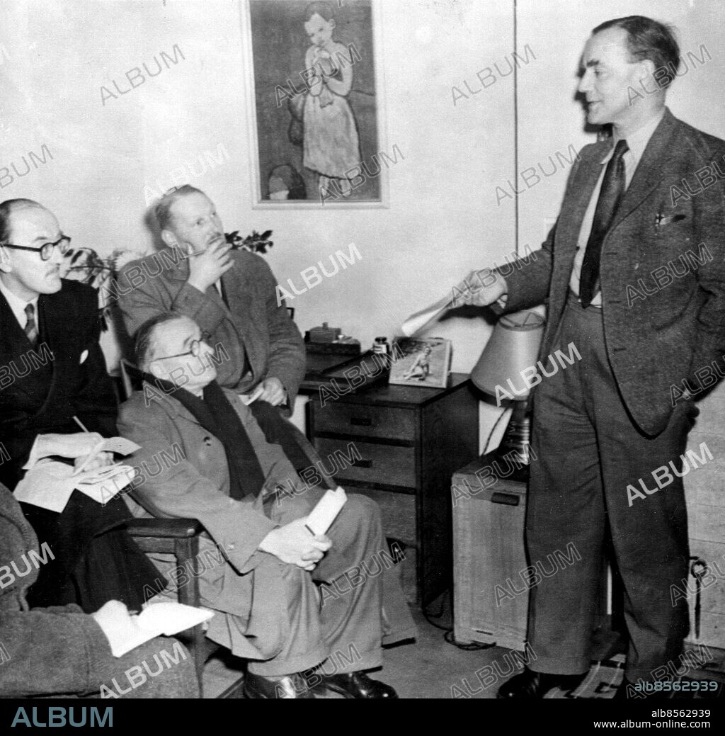 Orig. bildtext... PROFESSOR TALKS OF BANNED LECTURE TOUR Professor Cecil Frank Powell, Nobel Prize winner and head of the physics department of Bristol University, who was to have sailed for Germany today (Tuesday), instead held a Press conference at his Clifton, Bristol, home. He was to have lectured in six German universities on cosmic radiation and atomic physics, but last night the Foreign Office, who invited him to make the tour, withdrew the invitation. The Foreign Office explained today that this step was taken to avoid any appearance of political complexion, but Professor Powell, who said it was due to his association with the British Peace movement, described it as ridiculous. Picture shows: Professor Powell making his statement today (Tuesday). Anm. Nobelpriset i fysik 1950 Journalister persons: Cecil Frank Powell sites: STORBRITANNIEN.
