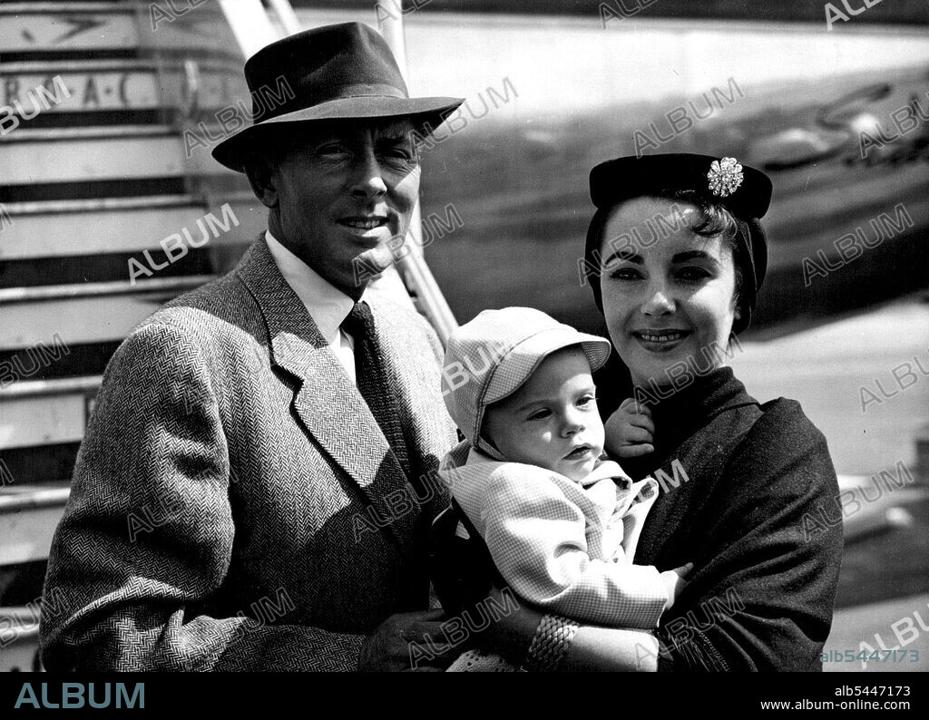 Wildings Arrive With Michael Junior -- British-born Hollywood stars Michael Wilding and Elizabeth Taylor pictured with their eight-months-old son Michael Howard Wilding on arrival at London airport by B. O. A. C. liner from New York to-day (Friday). Wilding and his wife have come over for a rest and to show Michael junior to his grandparents, Mr. and Mrs. Henry Wilding of ***** London. August 21, 1953. (Photo by Reuterphoto).