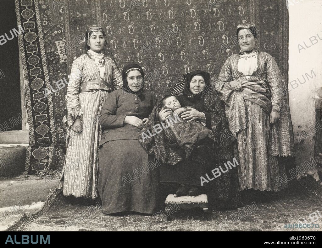 Erzerum: five generations of an Armenian family all living together in one house. Erzerum, portrait of a family. Photograph of an Armenian extended family. Women. Four women and a baby. Child.   Photographer: Henry Finnis Blosse Lynch . Source: Photo 430/7 27.