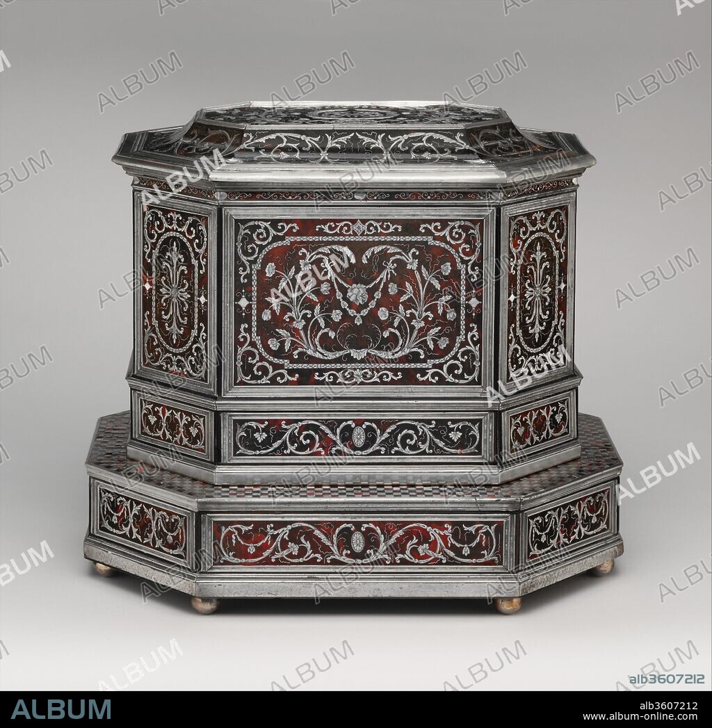 Wig cabinet (cabinet de coiffure). Culture: German, Künzelzau. Dimensions: 16 × 18 × 13 1/2 in. (40.6 × 45.7 × 34.3 cm). Maker: Johann Daniel Sommer II (German, 1643-1698?). Date: ca. 1685.
This wig cabinet is one of the most elaborate examples of its kind, a work of great refinement and supreme craftsmanship.[1] The exterior is decorated with extremely fine boulle marquetry, which retains many of the original engraved details.[2] Furthermore, it is an early example of the migration of this type of metal-and-tortoiseshell (or horn) marquetry and the High Baroque style in French furniture to the German-speaking cultural areas (see the catalogue entries for acc. nos. 1986.38.1, 1986.365.3). It is obvious that the creator of this cabinet, Johann Daniel Sommer II, occupies a key position in the history of European furniture-making. Unfortunately, the most important facts about his career remain obscure. He was born in 1643 into a dynasty of craftsmen. His grandfather was a carpenter, and his father, Eberhardt Sommer (1610-1677), worked as a carpenter, master builder, and gunmaker in the Franconian town of Künzelsau beginning in 1642. Other members of the family are documented as skillful craftsmen and gifted sculptors.[3]  Johann Daniel married in Künzelsau in 1667 and lived there until 1679. Then he sold his properties and moved to an unknown destination. One of his elaborate pieces, a traveling apothecary made for Karl August, margrave of Brandenburg-Kulmbach (1663-1731), contains silver utensils stamped with the Augsburg town mark for 1692-1700. One of these objects, a mortar, is dated 1692. By the late 1600s, however, Augsburg silver, especially sets of toiletry and pharmaceutical items, was esteemed all over Germany; thus, the assumption that Sommer lived in Augsburg must remain speculative. Besides, in Augsburg Sommer could not have used painted horn as a substitute for tortoiseshell as is done in the Museum's piece. The town guaranteed the quality of its luxury goods and ruled that "nobody should be deceived with oxhorn."[4]
It is inconceivable that the Museum's wig cabinet could have been realized without firsthand knowledge of contemporary French designs and marquetry and cabinetmaking techniques. Sommer most likely gained experience in Paris during his journeyman's travels before returning to Künzelsau. In the French capital he may have worked with a man named Jacques Sommer, a supposed relative who is mentioned as a cabinetmaker there until 1669. His widow continued the workshop, receiving a last payment in 1683.[5] He supplied Cardinal Jules Mazarin (1602-1661) and other members of the French court with elaborately decorated sets of furniture that included a mirror, matching table, and two candlestands. Alternatively, Georg Himmelheber has suggested that Johann Daniel Sommer may have worked closely with the French royal cabinetmaker Pierre Gole (ca. 1620-1684); he mentions a table by Gole in the Museum's collection (acc. no. 1986.38.1) as a possible link.[6] By the early 1660s Gole and his workshop were producing intricately inlaid furniture for the royal household of the Sun King. Whether Sommer ever worked with the great French marqueteur André-Charles Boulle (1642-1732) is not known. Boulle, only three months older than Sommer, became a master no earlier than 1666, by which time Sommer must have returned to Germany, for that year he supplied a game board and a dated and signed table to Count Albrecht von Hohenlohe-Langenburg.[7] It seems clear that Boulle and Sommer were influenced by an older master, probably Gole, but why so gifted a cabinetmaker and ornamentist as Sommer returned to his provincial roots instead of becoming a celebrated ébéniste in Paris like so many other German journeymen remains a mystery. The famous tapestry depicting a visit of Louis XIV to the court furniture workshop at Gobelins in 1667 illustrates a red (perhaps tortoiseshell) table with elaborate marquetry thought to be by Gole. It is extremely similar to Sommer's table of 1666 for Count Albrecht. The only noticeable difference is that the table seen in the tapestry has opulent gilt-bronze mounts, whereas Sommer's table has very refined but simpler pewter moldings.[8] The tortoiseshell and metal marquetry applied to both pieces was probably produced by the same technique. Sheets of tortoiseshell and metal were stacked together, a design was laid on the top sheet, and then all the sheets in the stack were cut together. The cutouts could be assembled in master patterns of light material set in a dark ground (première partie) or dark material on a light ground (contre partie).[9] It can be assumed that Sommer introduced this technique to Germany; moreover, the date on Count Albrecht's table suggests that Sommer may have played a major role in the development of this marquetry style in Paris while employed at Gole's workshop. If he was apprenticed as a boy in Germany to his uncle Johann Eberhart Sommer (1614-1693), who made guns richly inlaid with silver or pewter designs, Johann Daniel may have acquired metalworking skills before traveling to Paris.[10] It is not difficult to imagine the nephew transforming his uncle's playful volutes into his own signature zigzags.
The Museum's wig cabinet, with a lid in the style of a Chinese pagoda as an exotic detail, was a portable repository for that essential item of formal masculine attire, the wig. Dressing the hair and adjusting the wig were an important part of a gentleman's morning toilette, or lever,[11] when he was accustomed to receive the most important guests of the day as a special gesture of personal appreciation. As the occasion was public, all the accessories on the dressing table had to reflect the owner's taste and status. The extensive use of polished pewter (presumably in imitation of silver) and the precious silver mounts on this wig cabinet made it impossible that the object should escape the eye of any visitor.[12]
In its form-an elongated octagonal compartment mounted on a stepped base-the wig cabinet is typically South German.[13] When the cabinet appeared on the art market in 1996, it was attributed to Ferdinand Plitzner (1678-1724),[14] who may have studied with Sommer.[15] The key to identifying the patron, to attributing the work firmly to Johann Daniel Sommer, and to dating it at about 1685 are the cipher "JVG" on the cabinet's hinged lid and the stylized rose that appears in the center of several of the marquetry panels. Both refer to Johann Gottfried von Guttenberg (1654-1698), prince-bishop of Würzburg and duke of Franconia. The rose is part of the Guttenberg coat of arms. The use of the prince-bishop's monogram without the Guttenberg arms and the fact that the rose is almost hidden among the other marquetry decorations indicate that Guttenberg considered the wig cabinet a very personal item. Much more elaborately decorated but with almost identical ornamental details is a collector's cabinet, dated 1685, that the prince-bishop purchased from Sommer.[16] This cabinet, which stood in the public rooms of the episcopal palace, shows Johann Gottfried's official cipher as prince-bishop and duke on the central door, under a canopy of lily-of-the-valley sprays that resembles the one crowning the bishop's cipher on the lid of the Museum's wig cabinet. His full coat of arms appears on a carved ivory cartouche that surmounts the pediment over the center of the cabinet's facade. The cabinet can be identified in various inventories of the Guttenberg family and was recently acquired by the Würth Collection in Künzelsau, the town where Johann Daniel Sommer was born and spent much of his life.
Currently no more than twelve objects can be securely attributed to Sommer. The wig cabinet is undoubtedly one of the finest and best-preserved examples, all of which were made during the first vigorous phase of the expansion of luxury furniture-making in Central Europe. Furniture with boulle marquetry (let us call it "Sommer marquetry" in this case, since it was executed long before Boulle gained fame) became very highly regarded in the south German princely courts of the late Baroque period.
[Wolfram Koeppe 2006]
Footnotes:
[1] Henry Havard. Dictionnaire de l'ameublement et de la décoration depuis le XVIIIe siècle jusqu'à nos jours. 4 vols. Paris, 1887-90, vol. 4, cols. 1431-50. Based on extensive archival research and his familiarity with personal correspondence of the period, Alain Gruber has determined that many richly embellished boxes with only one large compartment dating from about 1650 to about 1750 were originally intended for the storage of wigs. Frequently decorated with gilded mounts and extravagant inlay, including pietre dure, these boxes are often mistakenly described as jewelry caskets. Dr. Gruber was kind enough to discuss this topic with me in New York on 16 November 2004.
[2] The drawer locks may once have had massive silver plates, which were removed and melted down, most likely during the Napoleonic wars. The keyholes were subsequently filled with silver rosettes decorated with engraved lotus leaves; see the conservation report in the archives of the Department of European Sculpture and Decorative Arts, Metropolitan Museum.
[3] Elisabeth Grünenwald. "Die Künstlerfamilie Sommer aus Künzelsau." Württembergisch Franken, n.s., 26-27 (1951-52), p. 280; and Stefan Kraut. "Die Familie Sommer im Überblick." In Die Künstlerfamilie Sommer: Neue Beiträge zu Leben und Werk, pp. 35-38. Sigmaringen, 1988, p. 36.
[4] Dieter Alfter. Die Geschichte des Augsburger Kabinettschranks. Schwäbische Geschichtsquellen und Forschungen 15. Augsburg, 1986, p. 91.
[5] Jules Guiffrey. Comptes des Bâtiments du Roi sous le règne de Louis XVI. 5 vols. Collection de documents inédits sur l'histoire de France, 3rd ser., Archéologie. Paris, 1881-1901, vol. 2, col. 391. See also Florian Knothe. "Les Artisans du Roi: A Family of Craftsmen." Master's thesis, Courtauld Institute of Art, University of London, 2002, pp. 28-36, on Sommer's widow and their daughter Catherine Sommer, who married the cabinetmaker Philippe Poitou (ca. 1640-1709).
[6] Georg Himmelheber. "Die Möbel des Johann Daniel Sommer." In Die Künstlerfamilie Sommer: Neue Beiträge zu Leben und Werk, pp. 121-40. Sigmaringen, 1988, pp. 124, fig. 5 (the Museum's piece by Gole), 125, figs. 6, 7 (pieces by Gole inspired by Sommer).
[7] Ibid., p. 125.
[8] The tapestry is illustrated in Olga Raggio, James Parker, Clare Le Corbeiller, Jessie McNab, Clare Vincent, and Alice M. Zrebiac. "French Decorative Arts during the Reign of Louis XIV, 1654-1715." The Metropolitan Museum of Art Bulletin 46, no. 4 (Spring 1989), pp. 4-5, fig. 5. On p. 52 of Alexandre Pradère. Les ébénistes français de Louis XIV à la Révolution. Paris, 1989. English ed.: French Furniture Makers: The Art of the Ébéniste from Louis XIV to the Revolution. Trans. Perran Wood. London, 1989, there is a detail illustration of the tapestry that includes the table.
[9] The technique was being used in Germany for marquetry in wood almost two generations earlier, as a South German buffet dated 1573 and other sixteenth-century pieces from Ulm and Cologne demonstrate; see Wolfram Koeppe. Die Lemmers-Danforth-Sammlung Wetzlar: Europäische Wohnkultur aus Renaissance und Barock. Heidelberg, 1992, pp. 118-20, 120-22, 126-27, nos. M53, M54, M60, color ills. pp. 250, 257.
[10] Albrecht Braun. "Zwei Gewehrkolben mit Reliefdekor von Johann Eberhart Sommer." In Die Künstlerfamilie Sommer: Neue Beiträge zu Leben und Werk, pp. 141-50. Sigmaringen, 1988, p. 144, fig. 5.
[11] Henry Havard. Dictionnaire de l'ameublement et de la décoration depuis le XVIIIe siècle jusqu'à nos jours. 4 vols. Paris, 1887-90, vol. 4, cols. 1431-50; and Peter Thornton. Seventeenth-Century Interior Decoration in England, France and Holland. Studies in British Art. New Haven and London, 1990, pp. 230-33.
[12] On the special pewter alloy used in the marquetry, see the condition report on the wig cabinet dated 30 September 2004 in the archives of the Department of European Sculpture and Decorative Arts.
[13] Wolfram Koeppe. Die Lemmers-Danforth-Sammlung Wetzlar: Europäische Wohnkultur aus Renaissance und Barock. Heidelberg, 1992, p. 206, no. M107, color ill. p. 250, and p. 242, M142, color ill. p. 257.
[14] Catalogue of a sale at Sotheby's, New York, 12 January 1996, lot 1044 (described as South German). See also Medieval and Renaissance Sculpture and Works of Art. Exh. cat., Blumka Gallery. New York, 1997 (in which the cabinet is attributed to Ferdinand Plitzner). The object was acquired by a Los Angeles private collector who subsequently lent it to the Los Angeles County Museum of Art until 2004, when it was acquired by the Metropolitan.
[15] On Plitzner's connections with Sommer, see Heinrich Kreisel. Die Kunst des deutschen Möbels: Möbel und Vertäfelungen des deutschn Sprachraums von den Anfängen bis zum Jugendstil. Vol. 2, Spätbarock und Rokoko. 2nd ed. Rev. by Georg Himmelheber. Munich, 1983, pp. 82-90; Wolfram Koeppe. "Möbel und Schaustücke." In Liselotte von der Pfalz: Madame am Hofe des Sonnenkönigs, ed. Sigrun Paas, pp. 179-88. Exh. cat., Heidelberger Schloss. Heidelberg, 1996, p. 184, no. 276; and Wolfgang Loescher. "Ein 'Boulle'-Möbel von Ferdinand Plitzner: Zuschreibung mit Hilfe von Konstrucktions- und Boulle-Technik-Details." Restauro, November-December 1997, pp. 454-59.
[16] Ursula Angelmaier, Ulli Freyer, and Andreas Huber. Der Kabinettschrank des Würzburger Fürstbischofs Johann Gottfried von Guttenberg von Johann Daniel Sommer. Künzelsau, 2004.