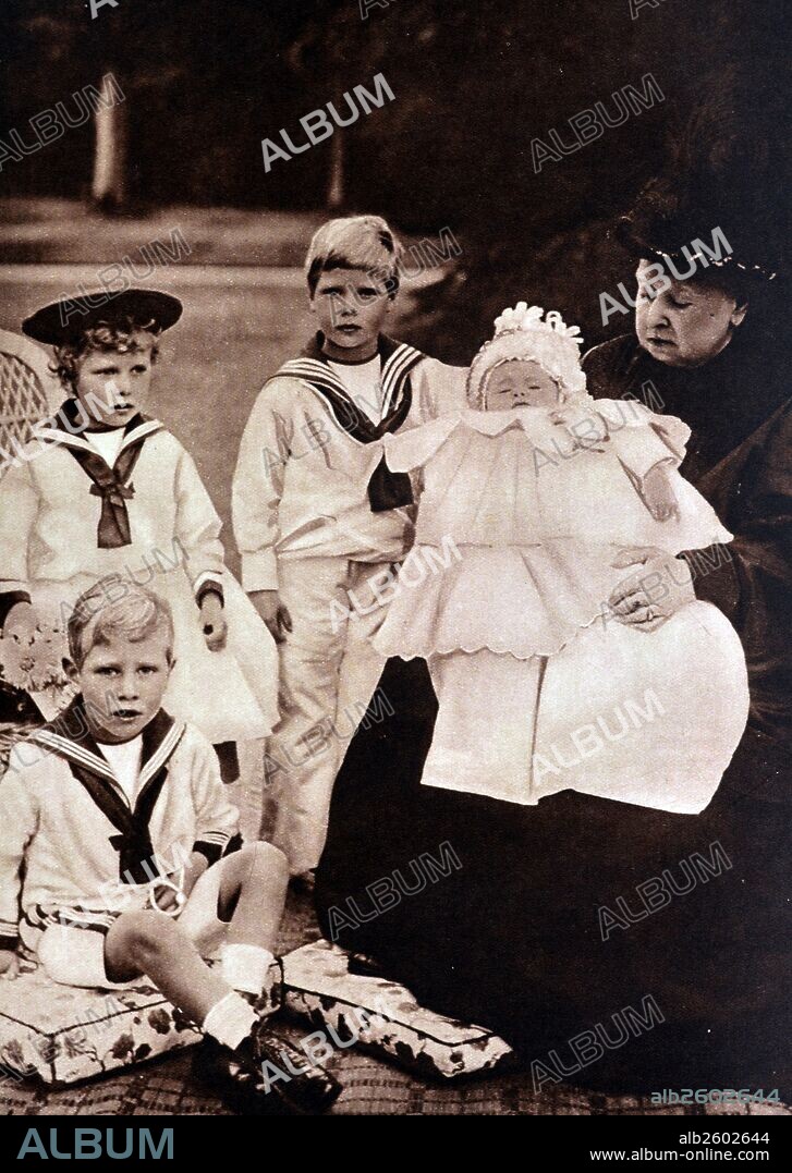 Royal Family portrait shows Queen Victoria with her 4 grandchildren. Princess Mary is shown wearing a hat, to her right is Prince Edward, Prince Albert is seated at the front and the newborn, Prince Henry is in Victoria's arms.