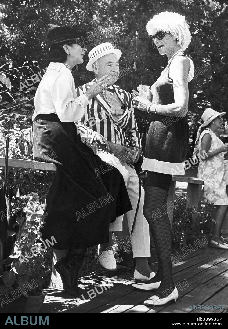 San Francisco, California:  August, 1970 People in 1960s dress at an afternoon outdoor cocktail party.