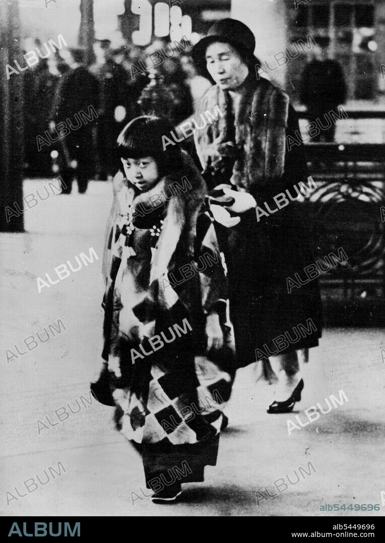 A Coy Princess -- Little Princess Teru, eldest daughter of the Emperor and Empress of Japan, still rather nervous of photographers, snapped at Tokyo station when she was on her way to Hayama, a seaside resort, to spend her spring holidays. May 21, 1934. (Photo by Associated Press Photo).