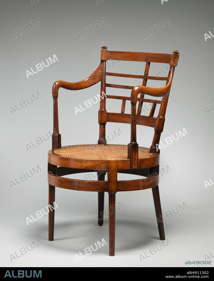After a design by Edward William Godwin, Armchair, British, ca. 1877,  British, Walnut, cane, Overall: 33 5/16 × 19 3/4 × 20 1/2 in. (84.6 × 50.2  × 52.1 cm), Woodwork-Furni - Album alb4911302