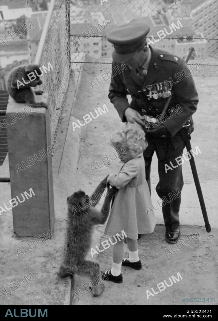 Prince Charles And Princess Anne Visit The Apes At Gibraltar -- "Now just wait a minute" one of the young Apes tries to take the bag of peanuts from little Princess Anne, when feeding them today.Before H.M. the Queen and the Duke of Edinburgh sailed from Gibraltar this morning, they paid a visit to the famous ape colony with Prince Charles and Princess Anne - legend has it that if the Apes disappear, Britain's Rule of Gibraltar will end. This was the second visit to the apes by Prince Charles and Princess Anne, and although prince Charles was a little unsure, Princess Anne Prance gaily from one ape to another, endlessly feeding them with peanuts. May 11, 1954. (Photo by Fox Photos).