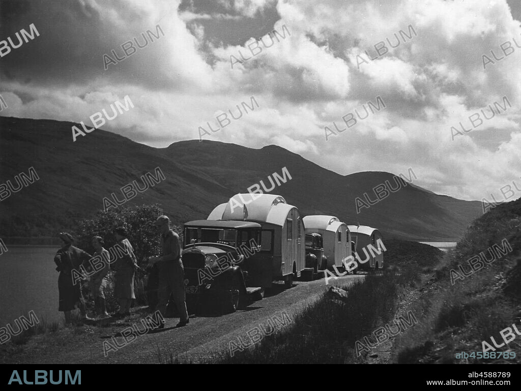 Group of cars and caravans camping in Scottish Highlands 1930's.