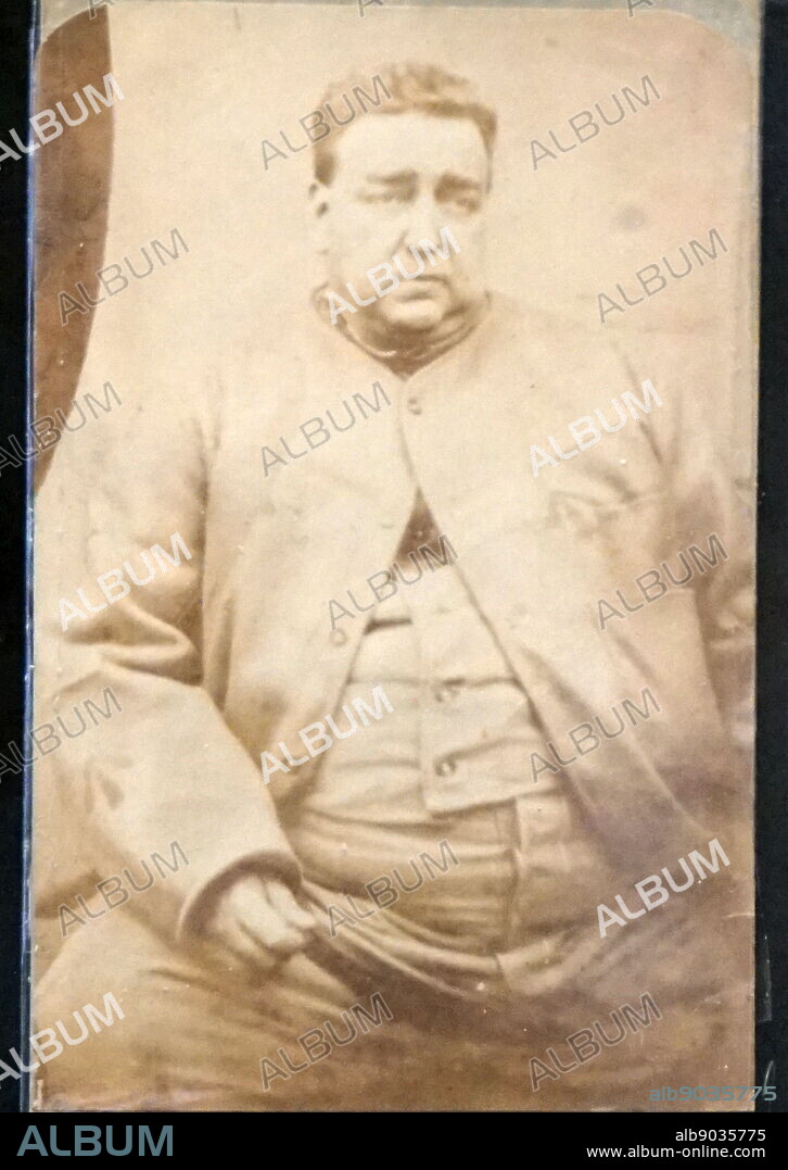 Photographic portrait of Roger Charles Tichborne (or Arthur Orton), the son of Sir James and Lady Henrietta Felicite Seymour Tichborne. In 1859 he was presumed dead after his ship was lost at sea. In 1865, Australian newspapers informed his mother that her son was in fact still alive. The man who claimed to be her son was believed to be an imposter by the majority of the family, however his mother and a few individuals believed him. In 1868 an issue was directed to be tried in the Court of Common Pleas as to whether the claimant was the heir of Sir James. After the trial Arthur Orton, the man claiming to be Tichborne, was arrested for perjury and was tried at the Bar in 1873.