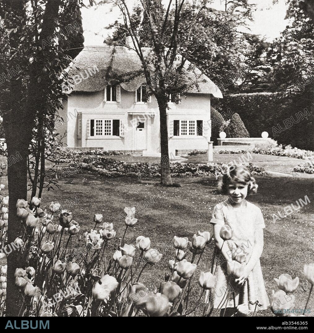 Princess Elizabeth at Y Bwthyn Bach or The Little House, situated in the garden of the Royal Lodge, Windsor Great Park, Berkshire, England. This miniature cottage was a gift to her from the people of Wales. Princess Elizabeth, future Queen Elizabeth II, seen here aged nine. Elizabeth II, born 1926. Queen of the United Kingdom, Canada, Australia and New Zealand.