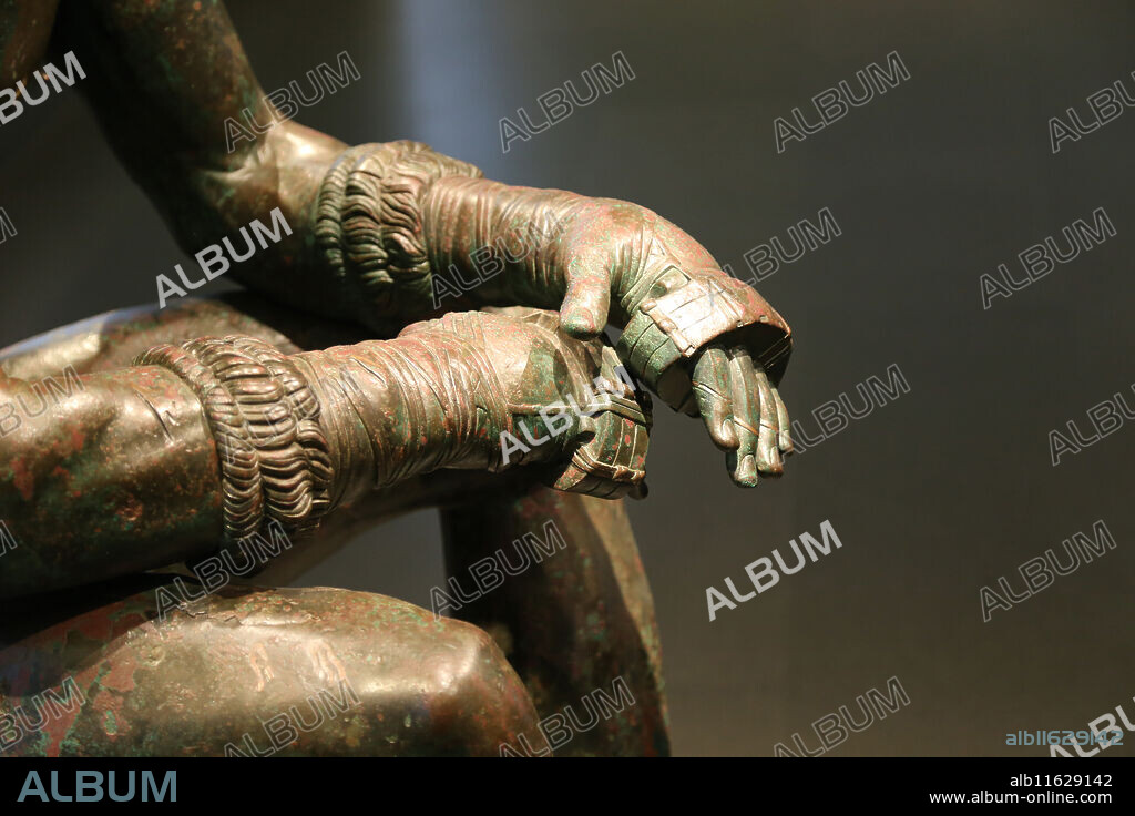 Boxer at Rest. Hellenistic Greek Sculpture. C. 330 BC. Sitting nude boxer at rest, still wearing caestus. National Museum of Rome. Massimo Palace. Italy. Rome.