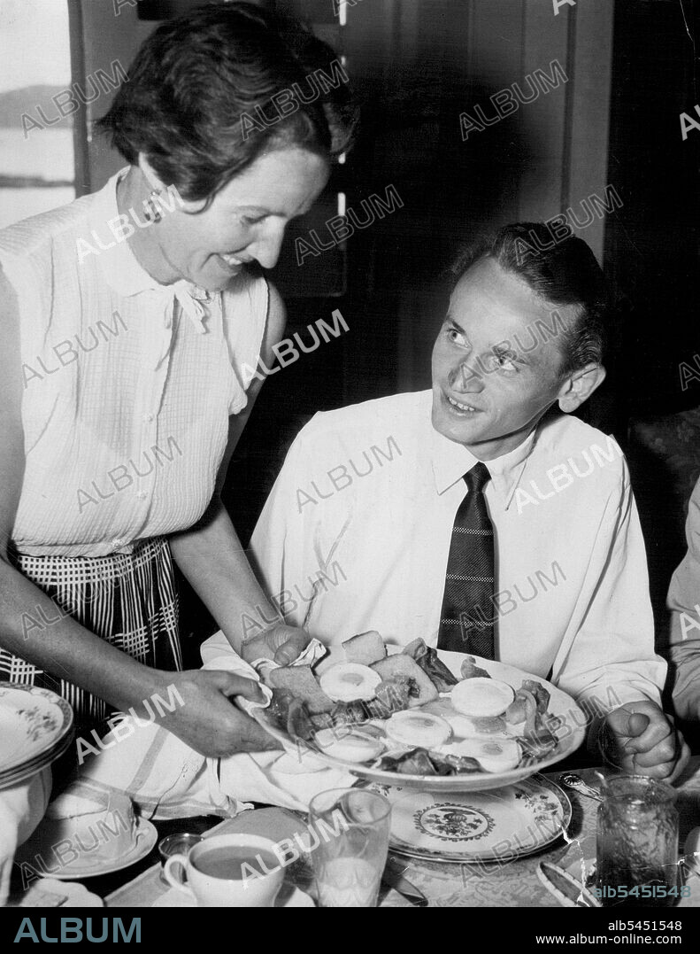 Hungarian runner Istvan Rozsalolgyi worked up an appetite by going to training before breakfast today. His hunger was well satisfied when his hostess, Mrs. Viv Chalwin sat him down to a meal of six eggs and bacon at the Chalwin's Beauty Point home. December 24, 1955.