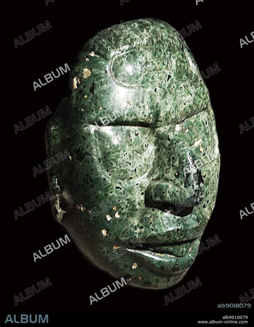 Face of the Mayan Sun God carved in a green stone, 600-900 AD Central American.