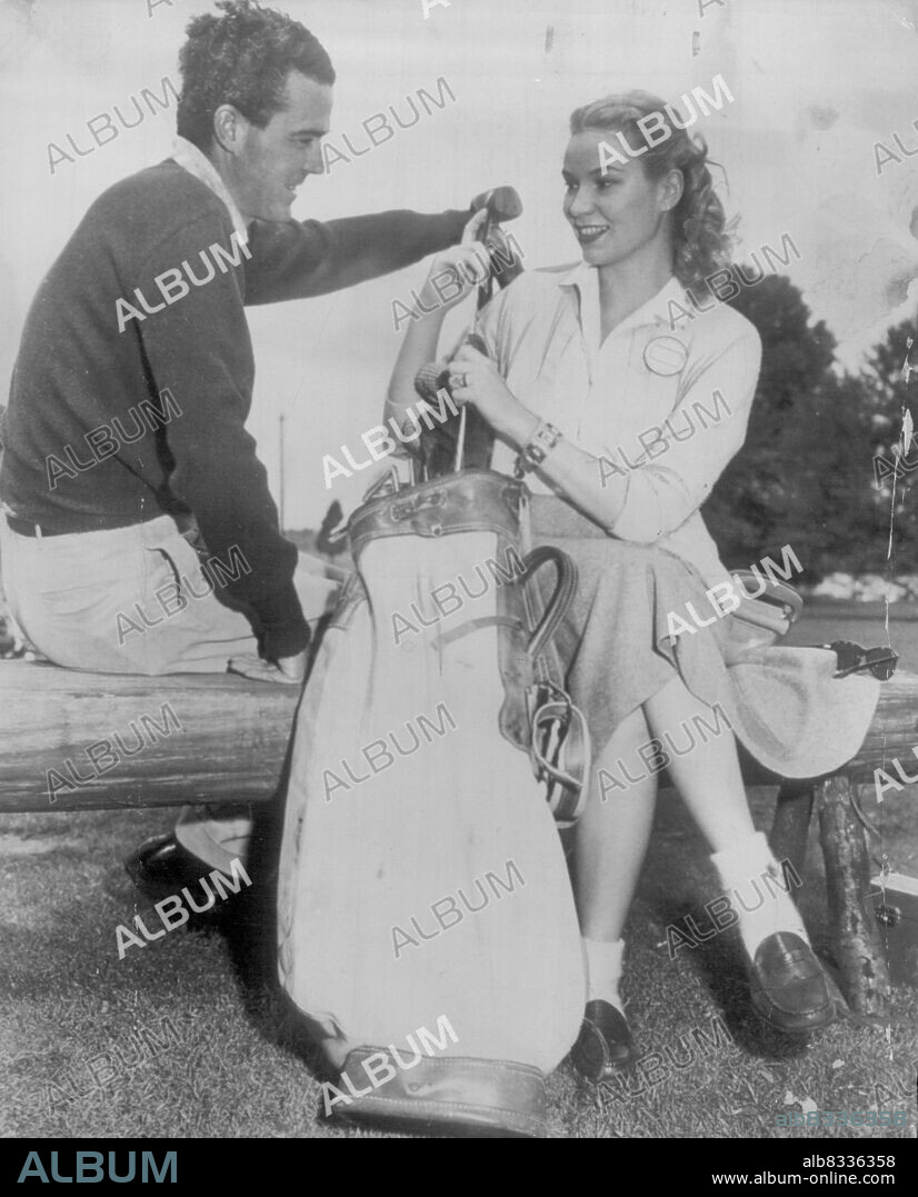 Sweeny and wife at masters -- Robert J. Sweeny, Jr., former British amateur golf champion, gets a helping hand from his bride in polishing up his clubs after the first round of the Augusta Masters Tournament here yesterday. Mrs. Sweeny, a New York debutante, is the former Joanne Marie Connelley. They were married at Palm Beach, Fla., Mar. 30, and make their home at Long Island, N.Y. He scored an 82 in the opening round of play.Girl friend - Mrs. Robert Sweeney. April 03, 1949. (Photo by AP Wirephoto).