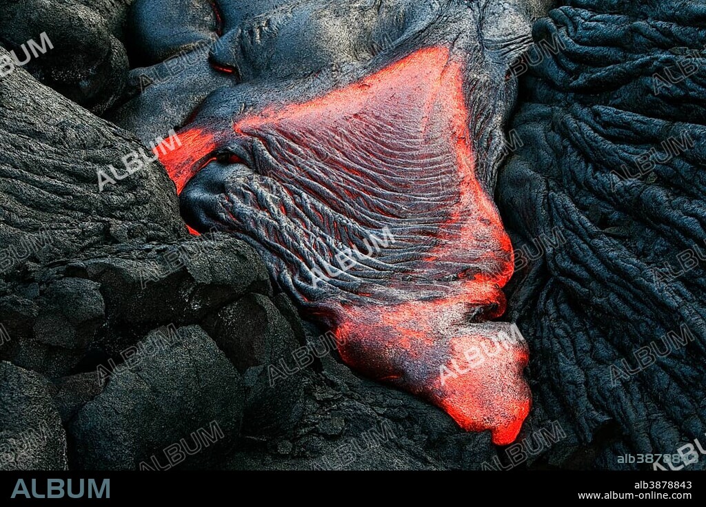 Molten pahoehoe type lava flowing from a crack in the East Rift Zone towards the sea, lava field of the Kilauea shield volcano, Hawai'i Volcanoes National Park, Kalapana, Hawai'i, USA, North America.
