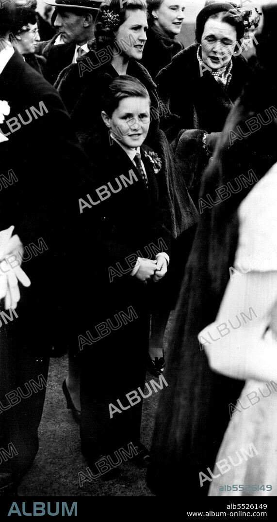 Guests at the wedding at St. Margaret's Westminster, are Winston Churchill  Junior, grandson of Prime Minister Winston Churchill, and his mother, Mrs. Pamela Churchill, first wife of the Premier's son. Randolph. Mrs. Pamela Churchill is the sister of Captain Digby. She came over from the South of France. where she now lives especially for the WeddingMias Dione ***** daughter of Admiral St. Vincent Sherbrooks, (Victoria Cross), was married to Captain Edward Digby, son and heir of Lord Digby, at St. Margaret's, Westminster.The Bridge wore her mother's wedding dress of white slipper satin embroidered with pearls and diamante.The reception was to be held St. Hutchinson House, for generations London home of the Derby family. December 18, 1952.