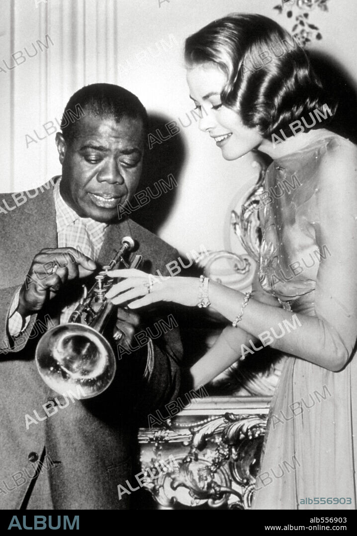 GRACE KELLY and LOUIS ARMSTRONG in HIGH SOCIETY, 1956, directed by CHARLES WALTERS. Copyright M.G.M.
