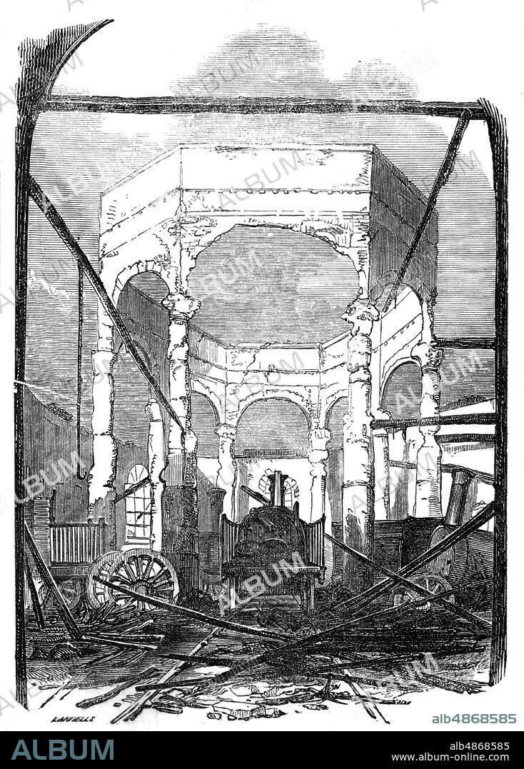 EBENEZER LANDELLS. Ruins of the Octagon Building, 1844. Damage after a fire at New Cross railway station in south-east London: '...at the works attached to the station of the South Eastern, Brighton, and Croydon Railways at New-cross, resulting in the destruction of property to an enormous amount...It consists of an assemblage of vast workshops, large lathe and planing machine rooms, furnace rooms, carpenters' and painters' rooms, carriage and fire engine houses; and a grand octagonal engine house...The upright walls of the upper story, or lantern, which was supported by four stone pillars, while the body of fire was raging beneath, was so charred and splintered by the intensity of the heat...while the wreck of the several locomotives was to be seen along the extensive line of shedding, presenting a most serious loss of this valuable property of the company'. From "Illustrated London News", 1844, Vol I.