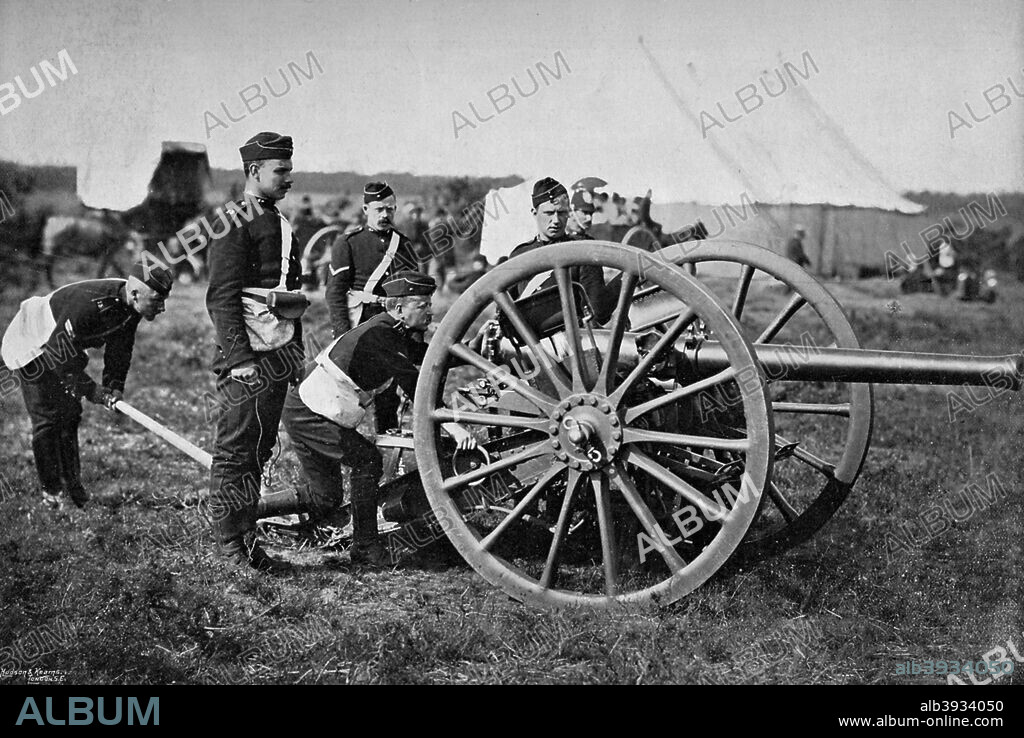 Gunners of field artillery drilling with a 12 pounder, 1895. A squad of gunners, in field service uniform, during training in the New Forest. A print from The Navy and Army Illustrated, 20th December 1895.