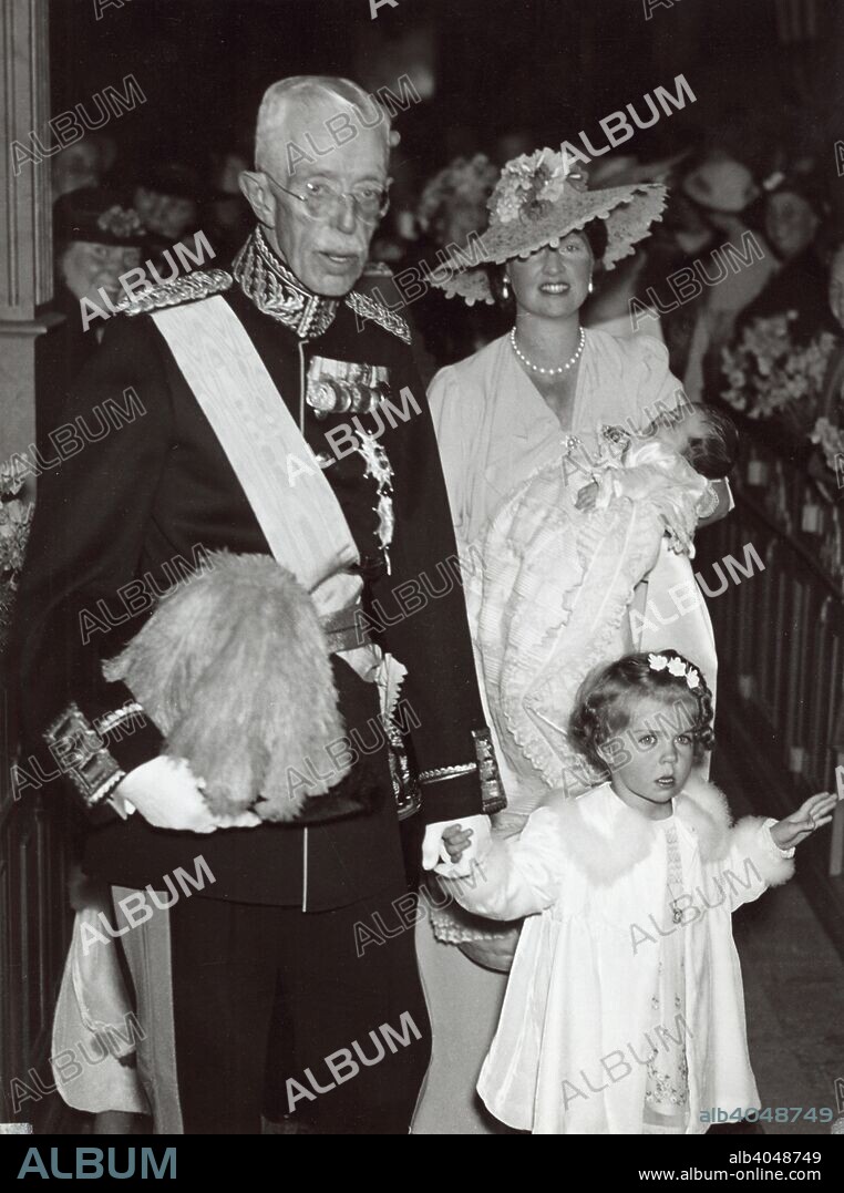 Christening of Princess Desiree of Sweden at the Church of Solna, Sweden, 30 June 1938. Princess Sibylla (1908-1972), the wife of Prince Gustaf Adolf, Duke of Västerbotten, carrying their third daughter, Princess Desiree (1938-), accompanied by their eldest daughter, Princess Margaretha (1934-), and King Gustaf V (1858-1950).