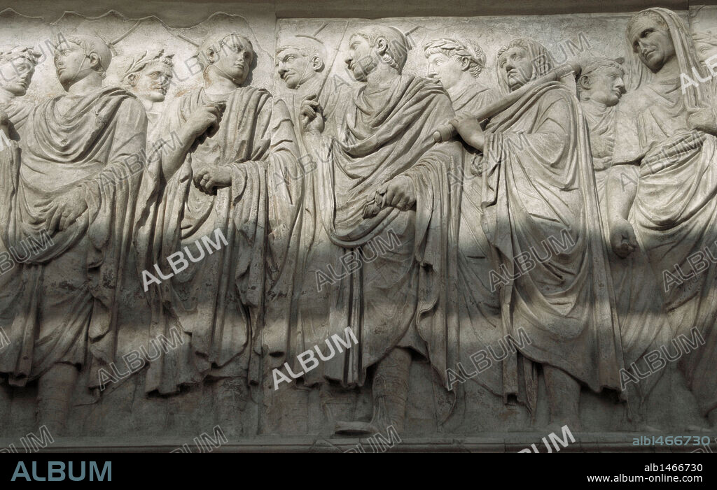 Roman Art. Italy. Ara Pacis Augustae. Processional frieze. Detail. Relief. Original South side. Central section. Four of the figures at the center have been identified as flamines, the leading members of the priestly orders of the state religion. They use distinctive leather caps (galerus), tied under the chin, with palmettes in front and behind the ears, with a point of olive wood mounted on a disk (apex) protruding from their caps. Next, flaminius lictor, carrying a ritual axe on his shoulder followed by Agrippa. Dated 13th century BC.  Museum of the Ara Pacis. Rome. Italy.