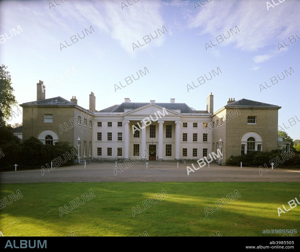 Kenwood House, Hampstead, London, 1989. The north front of Kenwood House, at the top of Hampstead Heath. The central section has a columned portico, with symmetrical wings extending forward on either side. The house and lawn are in shadow. Kenwood House was remodelled by Robert Adam in the neoclassical style between 1764 and 1773 and was bequeathed to the nation by the brewing magnate, the first Earl of Iveagh, in 1928. It houses the Iveagh Bequest, the most important private collection of paintings ever given to the nation, containing works by Rembrandt and others.