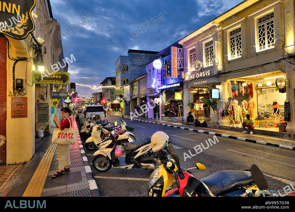 Thailand: Dusk falls over Thalang Road in the Old Town area of Phuket Town (Phuket City), Phuket, the road, with its numerous Sino-Portuguese style houses has become a major tourist attraction, with many of the houses converted into restaurants cafes and guest houses.<br/><br/>. The traditional architecture of Phuket Town is distinctively Sino-Thai and Sino-Portuguese. Having been influenced by migrant Chinese settlers from southern China, it shares a great deal with neighboring Straits Chinese settlements architecture in both the Malaysian cities of Penang and Melaka, and with Singapore.