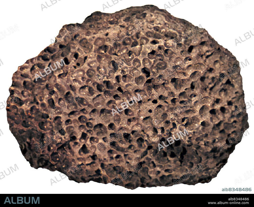 Basalt is volcanic rock riddled with holes caused by gas bubbles; it is found in great quantities in the oceans. It is between 3.2 and 3.8 billion years old.