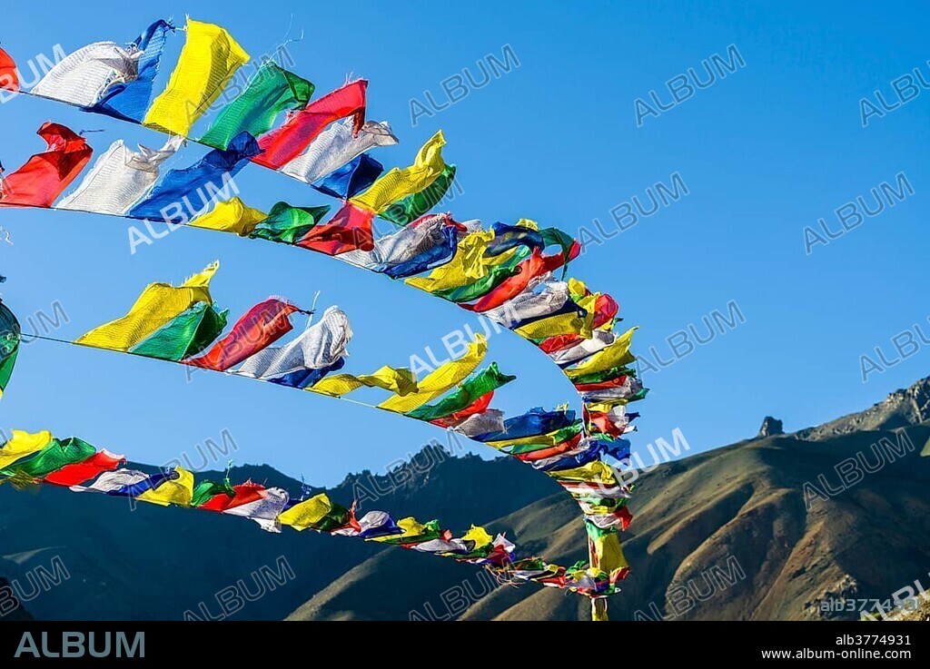 Tibetan prayer flags waving in the wind at Lamayuru Gompa, a monastery located in barren landscape, Lamayuru, Jammu and Kashmir, India, Asia.