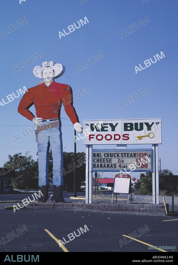 1980s America -  Key Buy Foods cowboy sign, Umatilla, Oregon 1987.