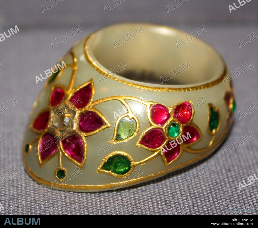 Thumb Ring. Mughal, 17th century. White nephrite jade set with emeralds, rubies and a diamond.