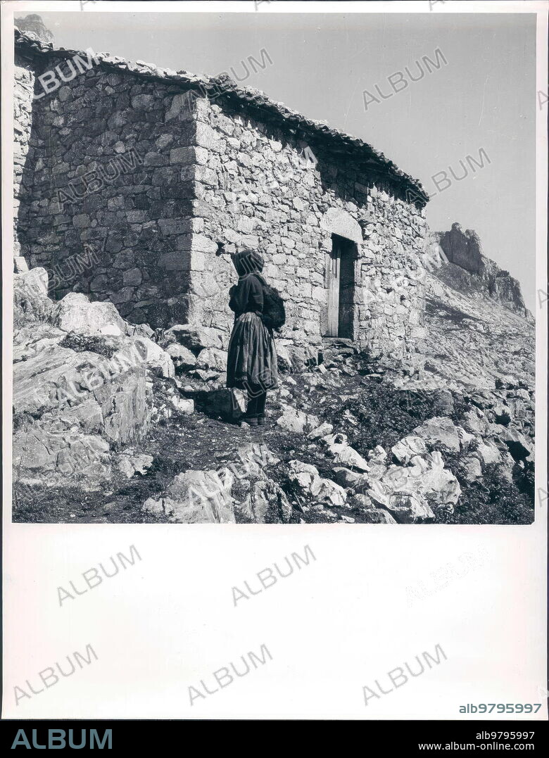 1950. Cabañas de Sotres, the highest town in the Picos de Europa. A Shepherd Leaving Her Hut.