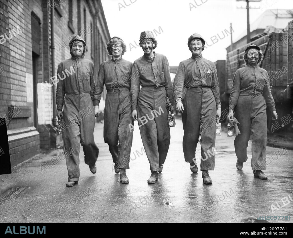 GIRLS OF THE AUXILIARY TERRITORIAL SERVICE VISIT A YORKSHIRE COAL MINE. : A party of the Auxiliary Territorial Service paid a visit to Hickleton Main Colliery, Thurnscoe, which is between Doncaster and Barnsley. The visit was arranged under the Army Education Scheme, the idea to give military personnel the opportunity of watching work in progress in the collieries where they saw for themselves the dangers and difficulties of coal mining. Their personal visit to the coal mine will also impress upon them the need for stringent economy in the use of fuel during the coming winter. Photo Shows: A.T.S.girls walking from the pit-shaft after watching the miners at work. United Kingdom 1942.