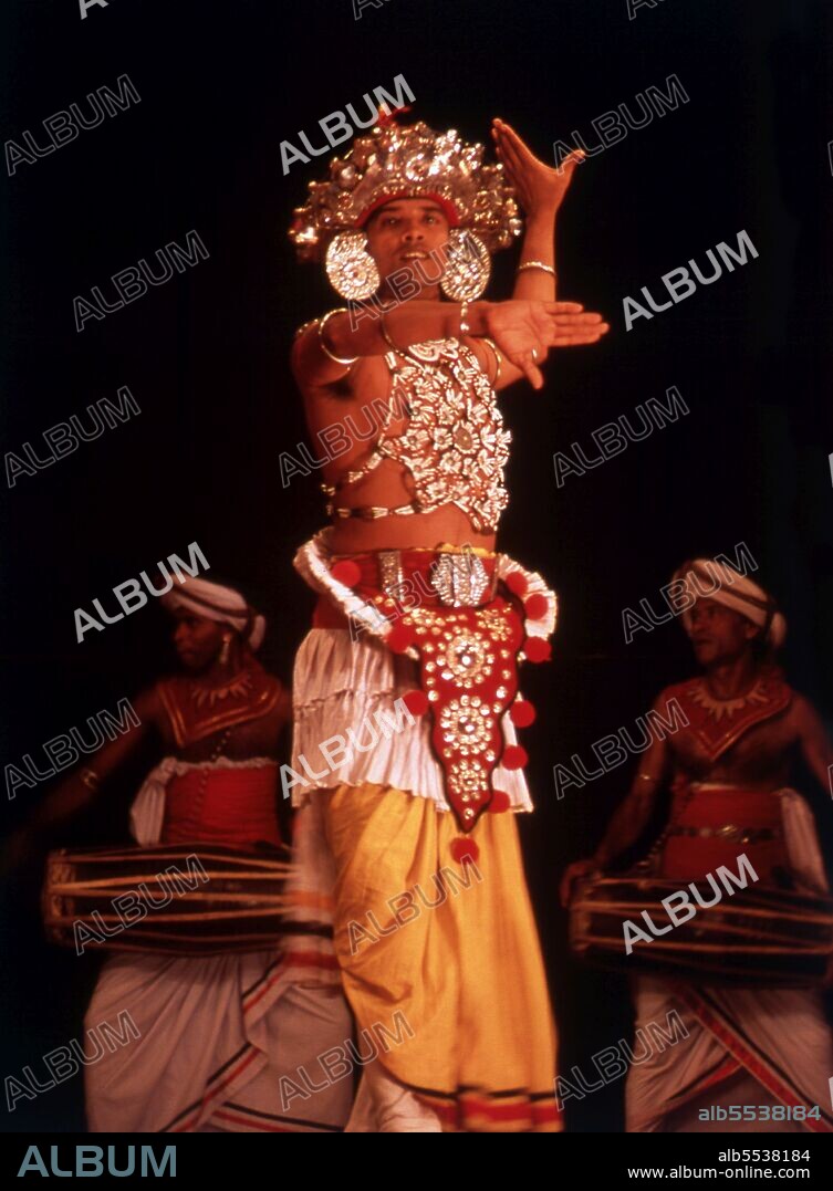 According to legend, the origins of Kandyan dance lie in an exorcism ritual known as the Kohomba Kankariya, which was originally performed by Indian shamans who came to Sri Lanka. It was originally performed by dancers who were identified as a separate caste under the Kandyan feudal system. They were aligned to the Temple of the Tooth and had a significant role to play in the Dalada Perahera (procession) held each year by the temple. Even though originally only males were allowed train as dancers, there are now several schools which also train women in the Kandyan dance form. However there is no definite Ves costume for women, and many female dancers have adapted the male costume in different ways.