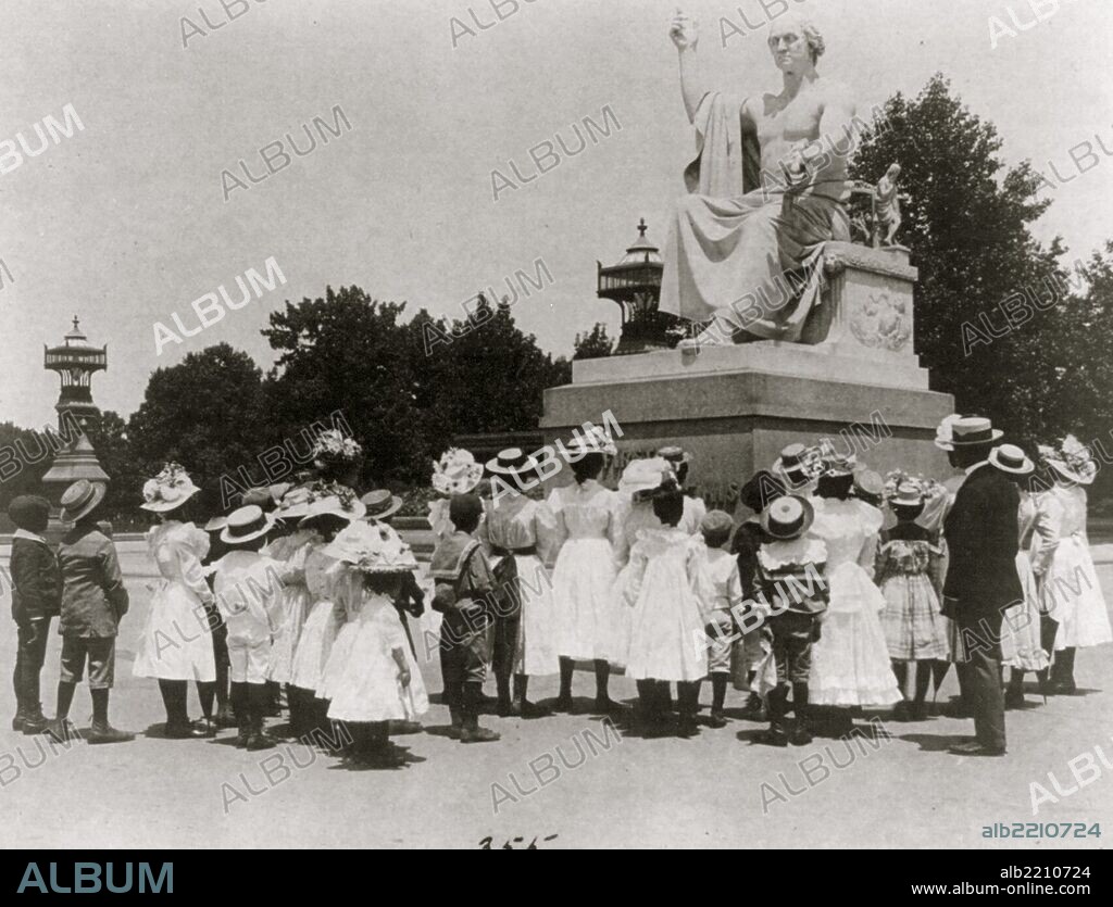 African American school children facing the Horatio Greenough statue of George Washington at the U.S. Capitol.