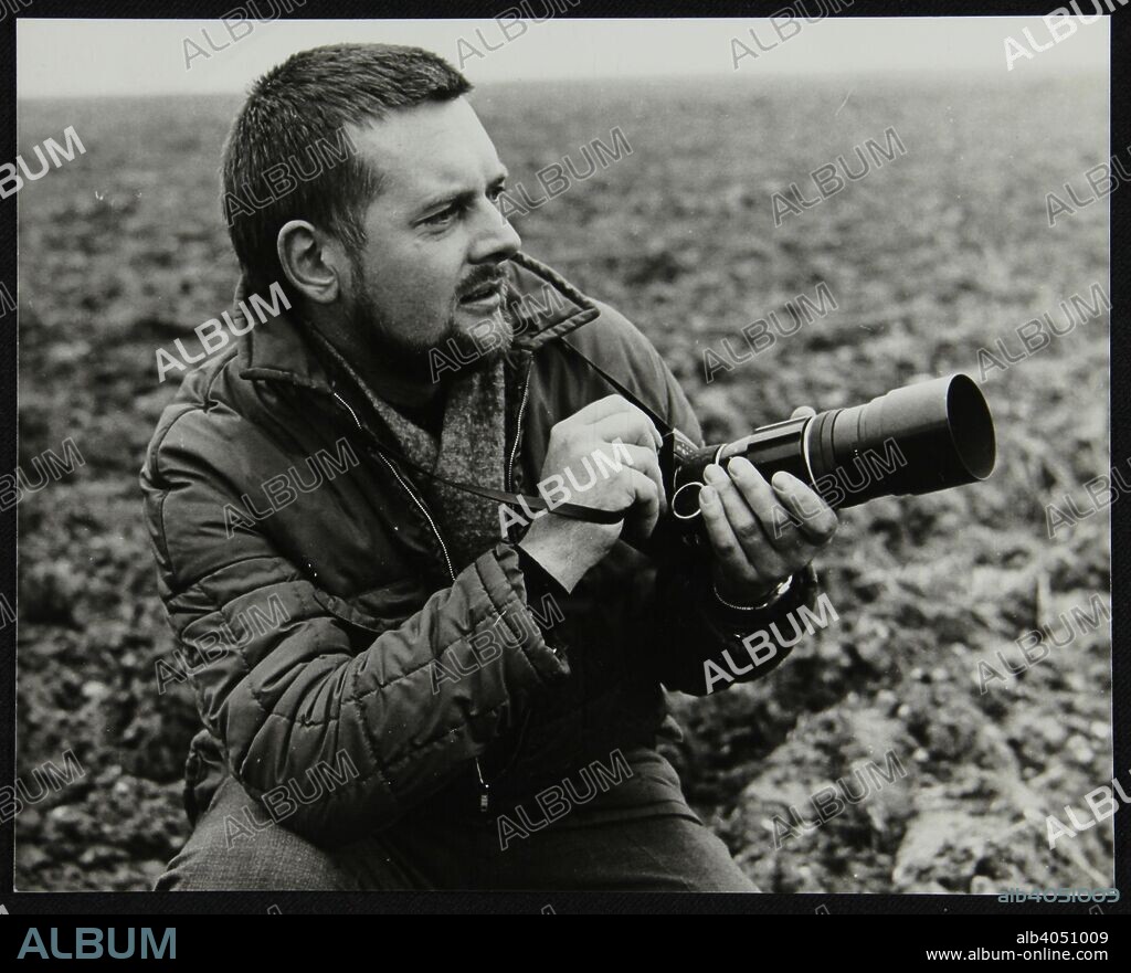 Portrait of photographer Denis Williams. Williams (1933-2009) was a Hertfordshire based press photographer who was an enthusiastic photographer of jazz musicians and events. His collection of photos and negatives is held by the National Jazz Archive in Loughton, Essex.