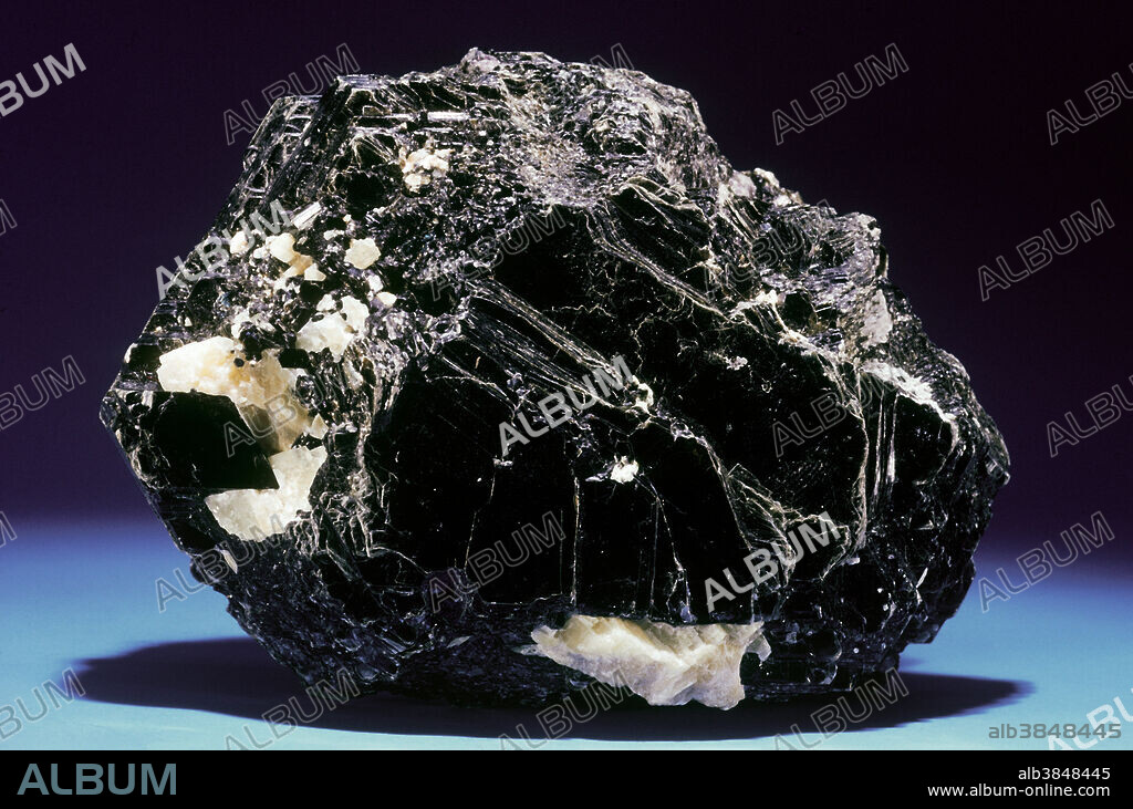 Biotite belongs to a silicate mineral family known as micas. Mica occurs in crystals of various colors, but its most interesting feature is perfect cleavage, the tendency to split along flat planes. The crystal structure of mica consists of sheets of atoms; the forces holding the atoms together within a sheet are strong, but those between the sheets are weak. Mica can be split into sheets that are transparent and microscopically thin. These sheets are flexible and in times past have even been used as window panes! The black iron-rich mica known as biotite is a component of many rocks throughout the world. Large fine biotite crystals occur in Canada and many other places.