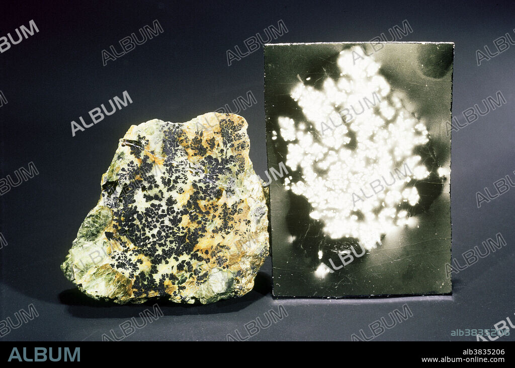 Uraninite is uranium oxide and an important ore of uranium. It is a black, brittle material, seldom occurring in crystals. Its usual occurrence is as masses or disseminated in rocks. Weathering creates alteration products that are generally yellowish or reddish in color. Radium was first discovered in uraninite, and the mineral's natural radioactivity will expose photographic film much as light does. A slice of uraninite placed on a sheet of film will produce a 'self-photograph', called an 'autoradiograph'. Grafton, New Hampshire is a well-known locality for this mineral.