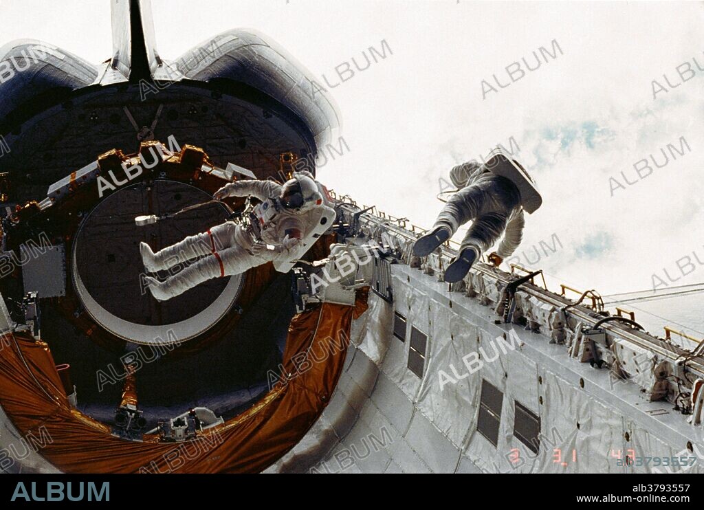 Astronauts Story Musgrave, left, and Don Peterson, right, float in the cargo bay of the Earth-orbiting space shuttle Challenger during their historic April 7, 1983, spacewalk on the STS-6 mission, the Challenger's first. They are restricted via tethers to safety slide wires. Challenger launched on April 4, 1983. It launched and landed nine times before ending in tragedy on Jan. 28, 1986. Just 73 seconds into mission STS-51L, a booster failure caused an explosion that resulted in the loss of seven astronauts, as well as the vehicle.