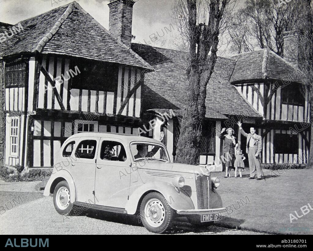 Photograph of a typical 1950s family outside of their home. Dated 1956.