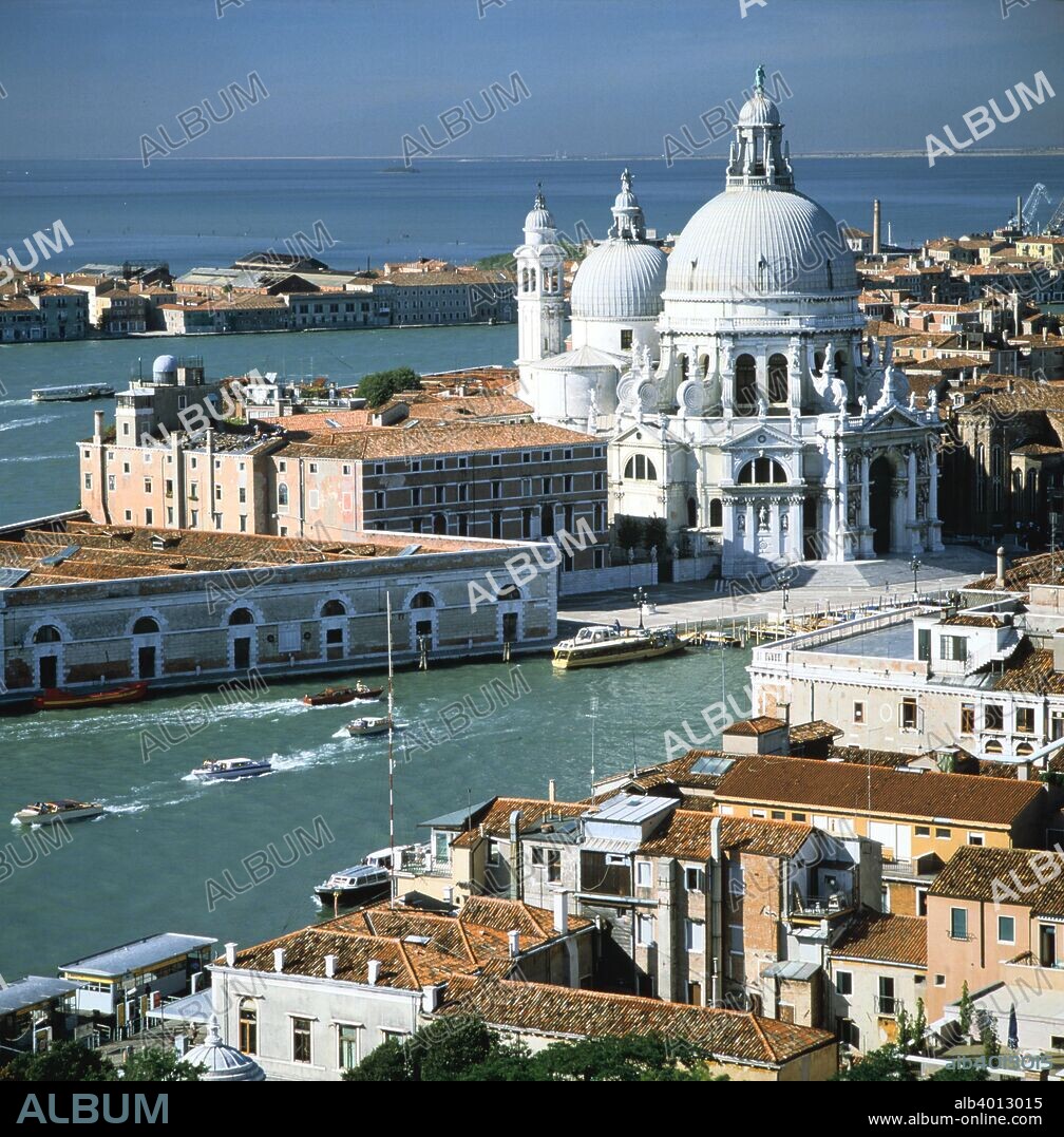 Church of Santa Maria della Salute, Venice, Italy. In 1630 the Venetian Senate decreed that if the city was delivered from an outbreak of the plague gripping it at the time, a new church would be built and dedicated to the Virgin Mary. The result was this Baroque church designed by Baldassare Longhena. Generally referred to as 'La Salute', it stands on the opposite side of Venice's Grand Canal from St Mark's Square, at the point where the canal empties into the lagoon. The church was truly Longhena's life's work, taking 51 years to complete before being inaugurated in 1681, the year before his death. The low building to the left of the church is the Dogana, the city's customs house.