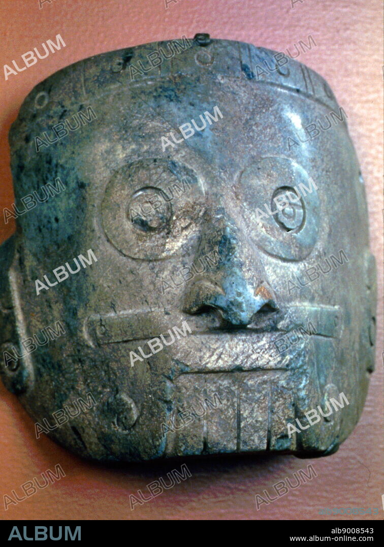 Mixtec mask of Tlaloc the Rain God; 13th-14th century Mexico, Mesoamerica. Made from Serpentine. This depiction of the rain god Tlaloc, has characteristic ringed eyes, prominent teeth, and an upper lip-moustache.