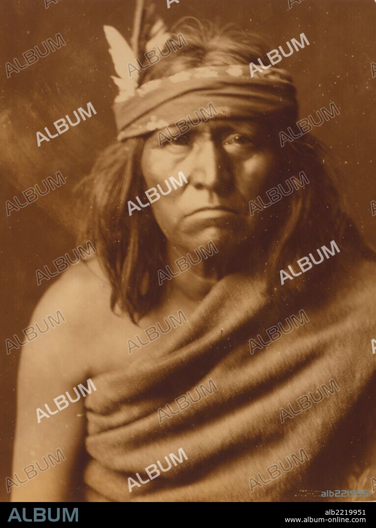 Head-and-shoulders portrait of an Apache man, facing front.